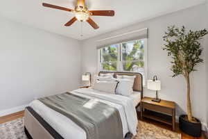 Bedroom featuring wood finished floors and a ceiling fan