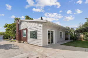 Rear view of house with a patio and a chimney