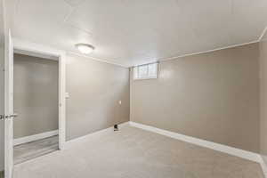 Below grade area featuring carpet and baseboards
