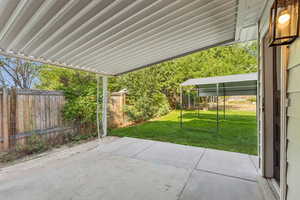 Fenced backyard with a patio
