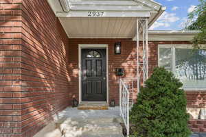 Doorway to property with brick siding