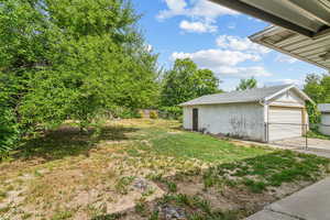 View of yard featuring an outdoor structure and a detached garage