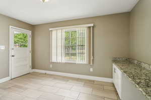 Unfurnished dining area featuring baseboards