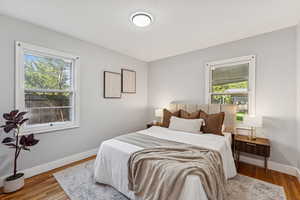 Bedroom featuring baseboards and wood finished floors