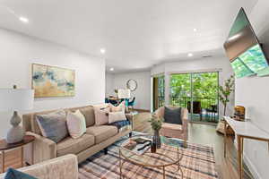 Living room with recessed lighting and light wood-style flooring