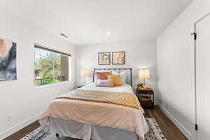 Hall Bedroom featuring baseboards, dark wood-type flooring, and recessed lighting