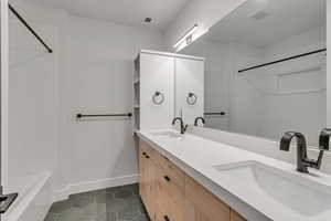 Bathroom with double vanity, tub / shower combination,