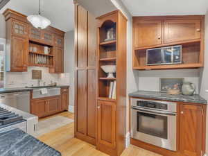 The updated kitchen blends modern luxury with timeless charm, featuring high-end appliances, a gas range with pot filler, generous storage, and a spacious pantry; all thoughtfully designed to honor the home’s original character.