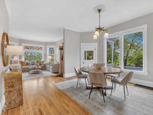 The semi-open layout offers seamless sight lines from the formal dining room to the living area, with large windows showcasing the beautifully landscaped side yard. Spacious and filled with natural light, it’s perfect for entertaining under soaring ceil