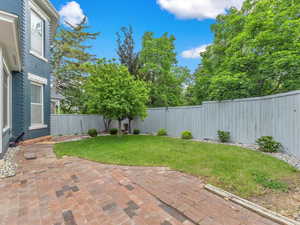 One of the few homes in the Avenues boasting a large, private yard; perfect for hosting gatherings with a secure fence, elevated position above the street curve, and mature trees offering both beauty and seclusion.