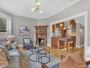 Connected to the chef’s kitchen, the inviting family room features a stunning fireplace with an intricately carved wood mantel and elegant brass inserts. Bathed in natural light, this comfortable space overlooks the private fenced yard and serene courty