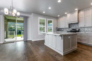 Kitchen featuring stainless steel range, plenty of natural light, backsplash, baseboards, and recessed lighting
