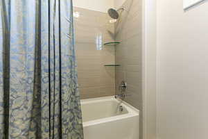 Bathroom with shower / bath combo with shower curtain