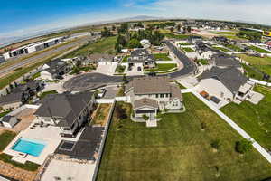 Aerial overview of property's location with nearby suburban area, a mountain backdrop, and a pool