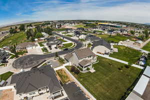 Aerial view of property's location with nearby suburban area and mountains