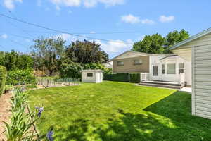 View of yard featuring a wooden deck and a vegetable garden