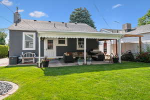 Back of property with an outdoor hangout area, central AC unit, a patio area, and roof with shingles
