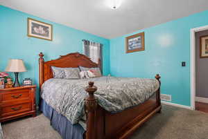 Carpeted bedroom featuring baseboards