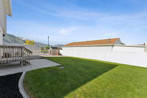 View of yard with a patio area and a deck with mountain view