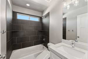 Bathroom featuring vanity, bathing tub / shower combination, toilet, and recessed lighting