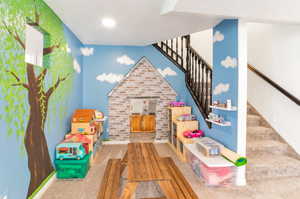 Rec room featuring carpet flooring and baseboards