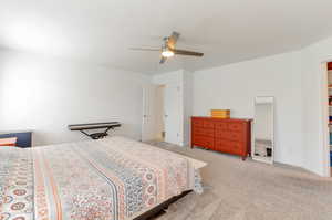 Bedroom with carpet, ceiling fan, and baseboards