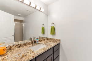 Bathroom with vanity and a stall shower