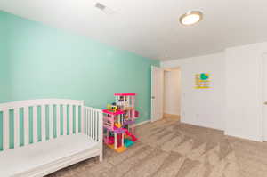 Carpeted bedroom featuring baseboards