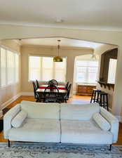 Living Room/Dining Room featuring wood finished floors, plenty of natural light and breakfast bar