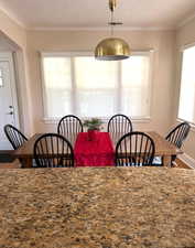 Dining room featuring wood finished floors and baseboards