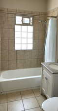 Full bath with vanity, tile patterned flooring, and shower / bath combination with curtain