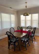 Dining Room featuring plenty of natural light, finished wood floors, a textured ceiling, and baseboards