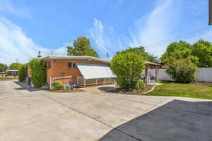 Back of property featuring brick siding and driveway