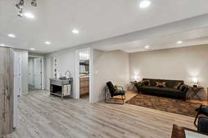 Living room featuring wood finished floors, recessed lighting, and baseboards