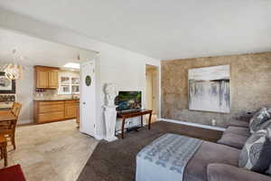 Living room featuring baseboards and a chandelier