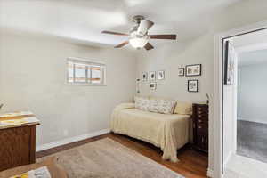 Bedroom featuring baseboards, ceiling fan, and wood finished floors