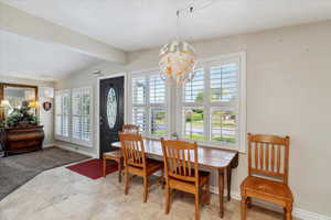Dining space with a chandelier and baseboards