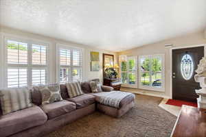 Living room with plenty of natural light and a textured ceiling