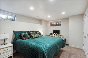 Carpeted bedroom featuring recessed lighting and baseboards