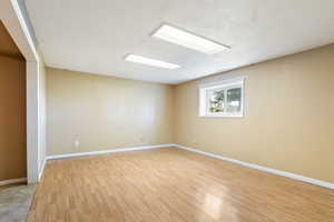 Empty room with light wood-style floors and baseboards