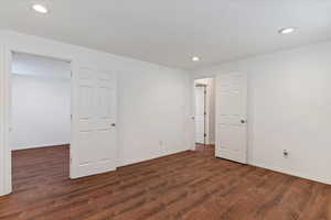 Unfurnished bedroom featuring wood finished floors, baseboards, and recessed lighting