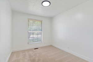 Unfurnished room with baseboards and carpet flooring