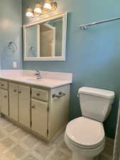 Mater Bathroom with toilet, vanity, tile patterned floors, and baseboards
