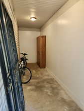 storage area behind the garage. Doorway to the garage and exits to the back yard.