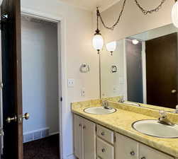 Full bath featuring double vanity