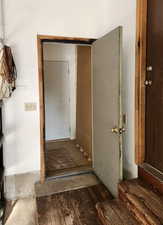Passage to storage area behind the garage. Also exits to the back yard.