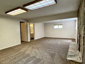 Carpeted empty room with baseboards