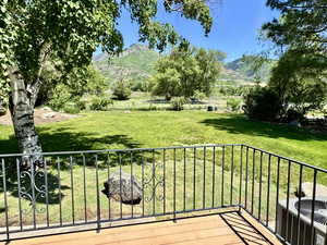 Back yard from rear deck, featuring a mountain view