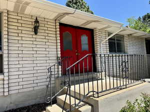 Doorway to property with brick siding