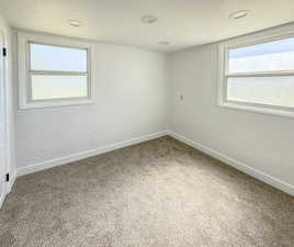 Spare room with carpet, baseboards, and recessed lighting